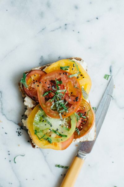 Tomato toast with macadamia ricotta, shiso, and black lava salt