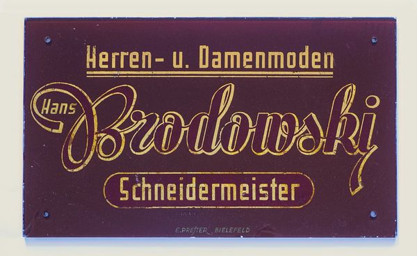 German hand-lettering. Gilded letters behind glass.