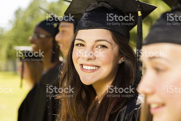 Education Latin Girl And Friends At Graduation Cap Gown stock photo 480937265 | iStock