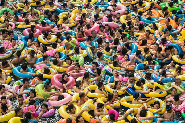 Chinese tourists swim in a lake called the "Dead Sea of China" at a resort in Suining on July 22.