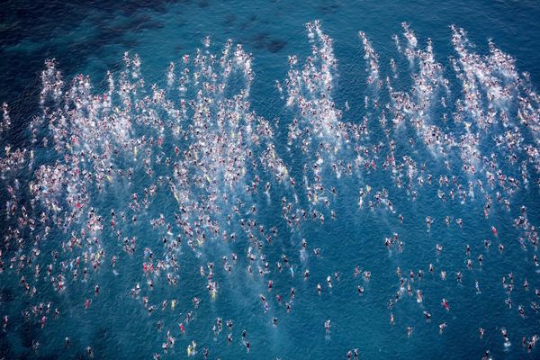 Athletes compete in the swim portion of the 2016 IRONMAN World Championship triathlon in Kailua Kon…