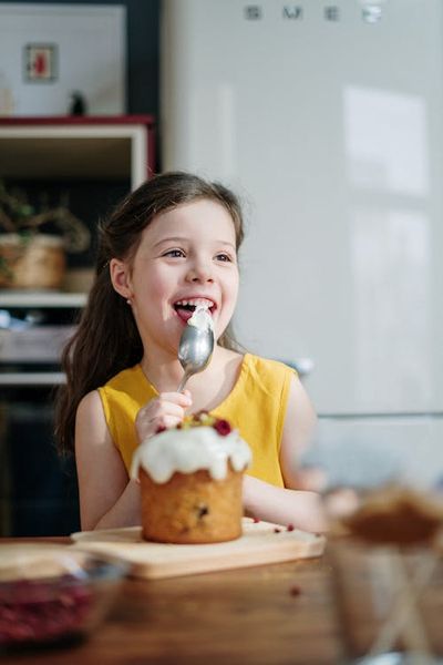 Girl in Yellow Shirt Eating Cake · Free Stock Photo