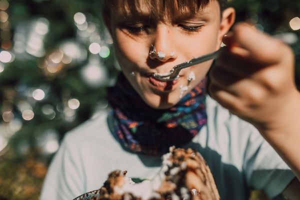Close-Up Photo of a Boy Eating Cake · Free Stock Photo