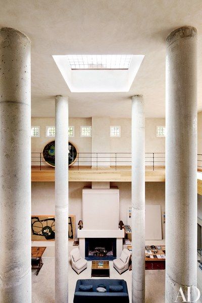 Measuring 36 feet high the room is where the designer meets with clients the columns and floor are …