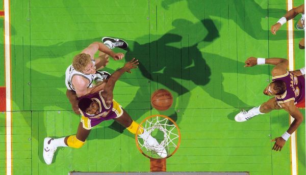 Rival stars Magic Johnson and Larry Bird of the Celtics battle beneath the rim in Game 1 of the 198…