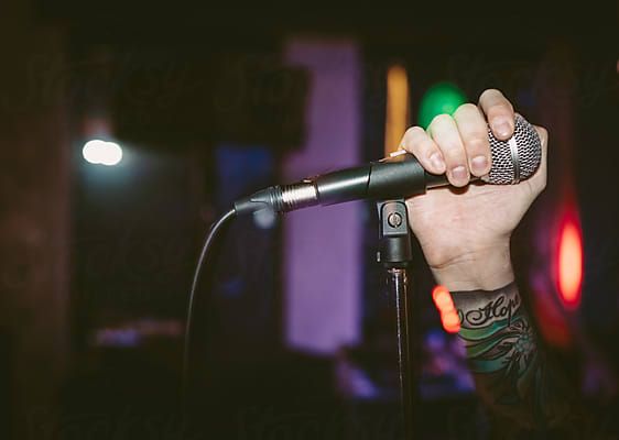 Rock Singer Holding Microphone by Luminafor Stocksy United
