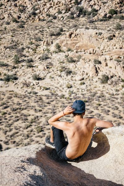 An outdoor photographer taking his time to look out over the vast desert plains.