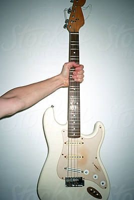 Hand holding an electric guitar by Di Nafor Stocksy United