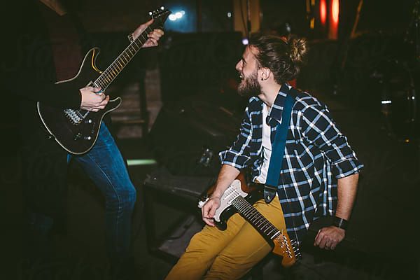 Guitarist Tuning Guitar on Rehearsal by Luminafor Stocksy United
