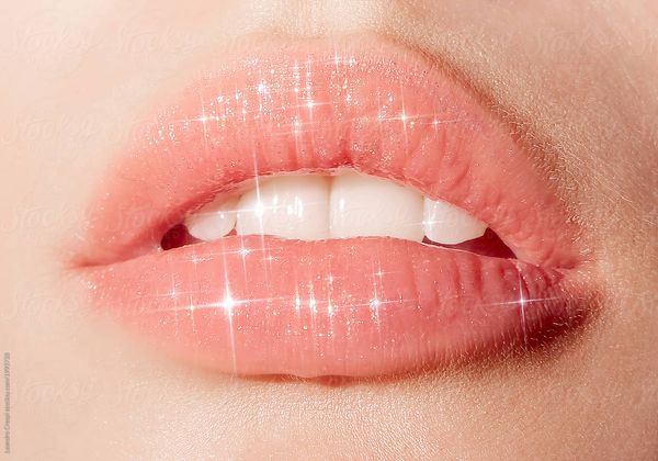 Mouth closeup Juicy sparkling lips macro shot.