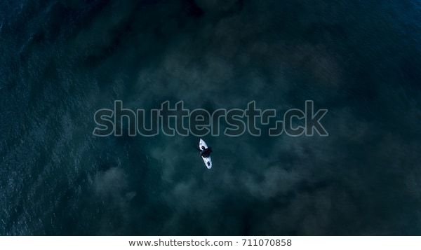 Surfer in Dark Ocean, Aerial Perspective