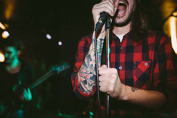 Punk Singer Performing With His Band by Luminafor Stocksy United