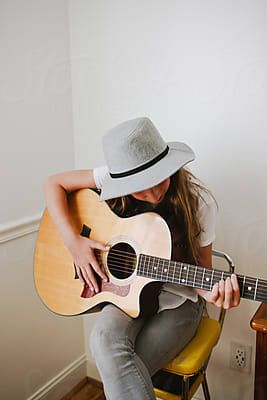 Young Girl Playing Guitar by Erin Dragofor Stocksy United
