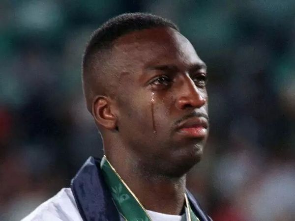 a-tear-runs-down-400-meter-champion-michael-johnsons-cheek-as-the-national-ant