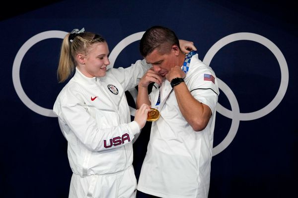 UNITY - Won gold and places her medal over the neck of her father and coach, Brian - Jade Carey, a …