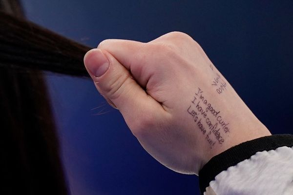 220217032332-olympics-curler-notes-hand