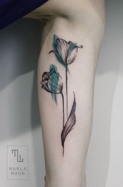 A mystical looking tulip tattoo in black and green ink.  Almost looking like a sketch, the tulip is…
