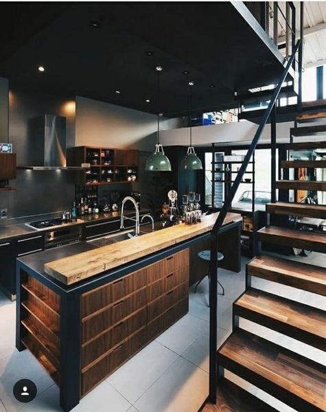 Industrial kitchen with wooden rustic elements, and thick industrial metal staircase.