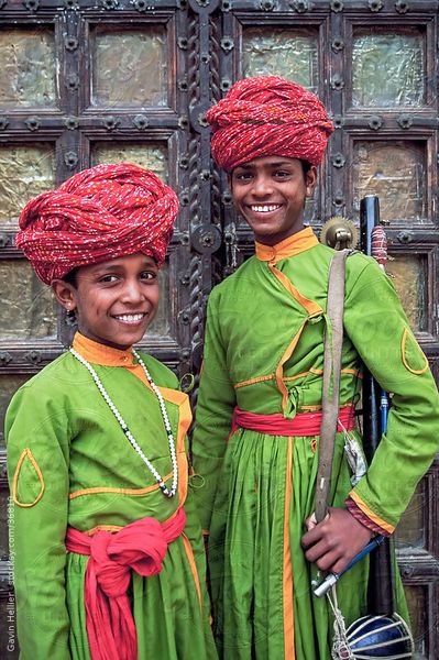 Portrait of two young boys in turbans standing in front of a wooden door, Samode Palace, Jaipur, Ra…