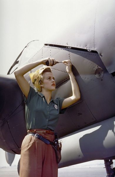 A female Lockheed employee works on a P-38 Lighting - Burbank, CA - 1944