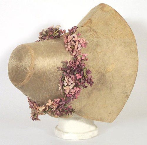 Fur-felt bonnet with bunches of lilacs or violets around the crown, 1820-1830.