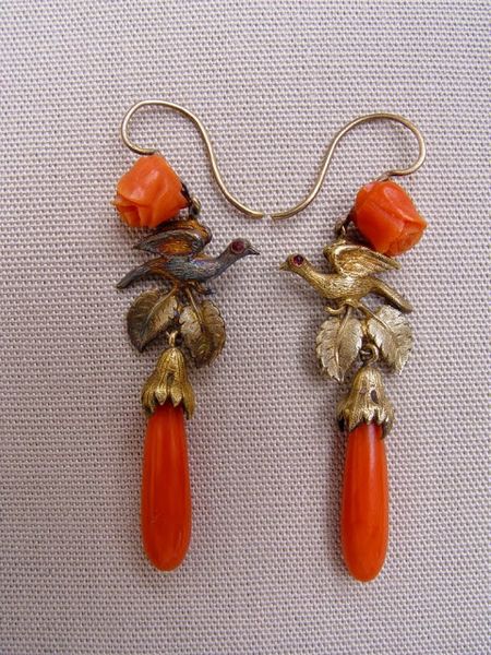 Made in England in the 1830s, this pair of earrings is hung with coral drops.  A setting of bloomed…