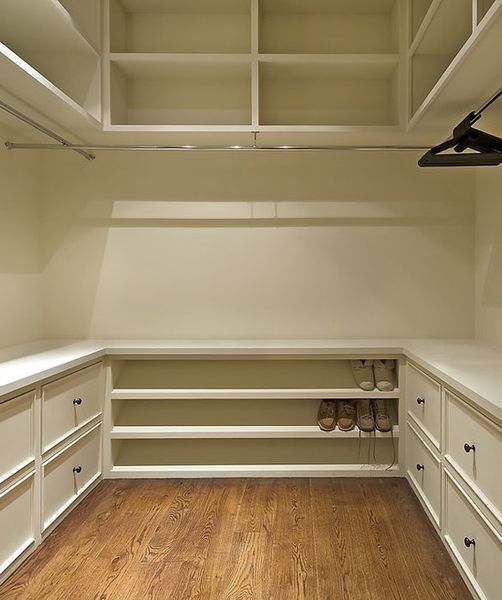 master closet. shelves above, drawers below, hanging racks in middle.