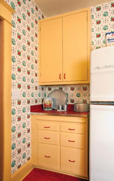 The sunny yellow cabinets and red Marmoleum flooring and countertops are a great fit with the Bradb…