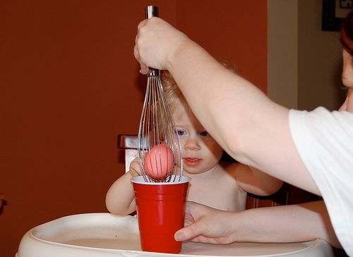 Using a whisk to dye Easter Eggs