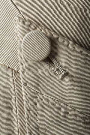 Detail of the fastening on a pair of breeches from a man's cream silk wedding suit, 18th century, p…