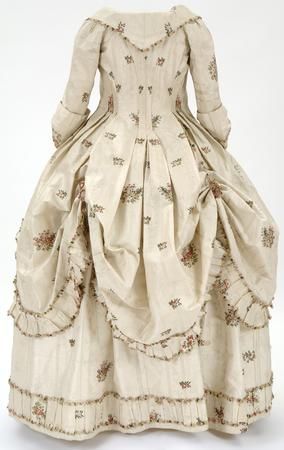 1780-1781. Cream brocaded silk woven with clusters of flowers in pinks and greens. Worn by Mary Mcd…