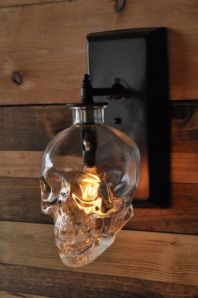 laughingsquid: “Lighting Expert Creates a Spooky Skull Wall Sconce From Recycled ‘Crystal Head …