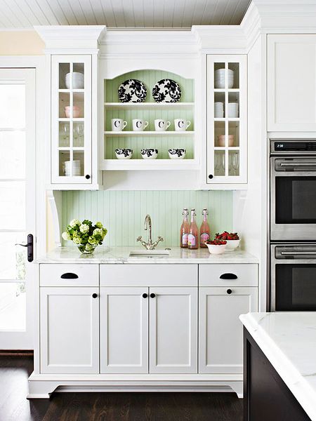 a minty green beadboard backsplash adds a touch of color to a white cottage kitchen