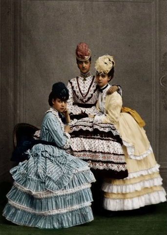 Tinted portrait of three young women, 1870s.