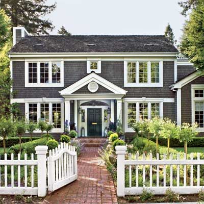 beautiful colonial with fresh white trim and lots of greens