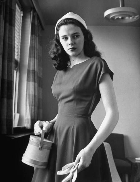 Madeline Balcar modeling teen-age fashions, wearing a basic dress of gabardine, 1949.