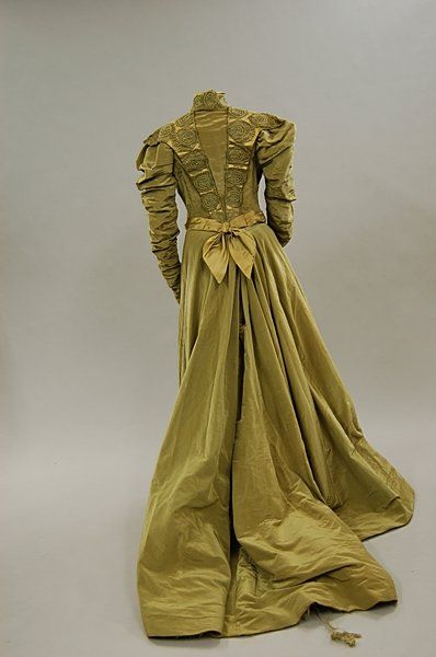 A green satin grosgrain afternoon dress, circa 1900, the bodice trimmed with satin and applied with…