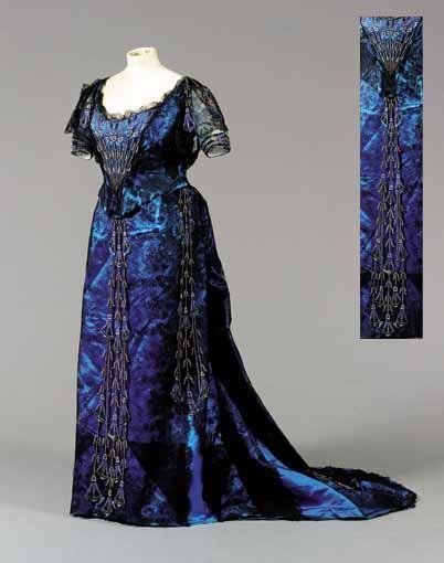 Circa 1900 Ball gown by Worth. Kingfisher blue satin overlaid with black Chantilly lace. Bodice and…