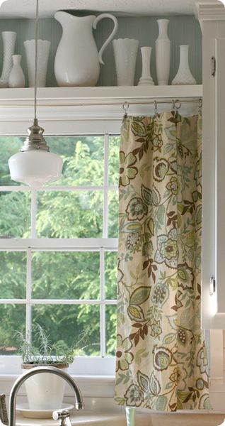 Kitchen Window Treatment:  Shelf between cabinets with display items, curtain hung beneath.