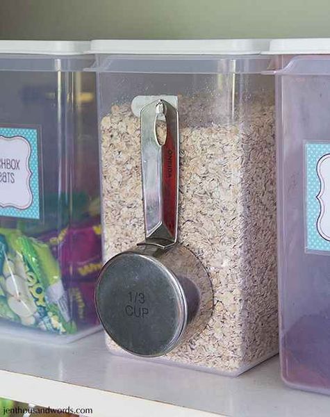 Attach a command hook to the side of food canisters for easy scooping. | 52 Meticulous Organizing T…