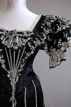 A striking black satin and tamboured tulle evening gown, circa 1893-4, labelled W Tebbs & Sons, Bri…