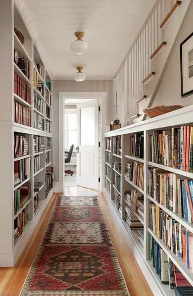 Hallway lined with bookcases