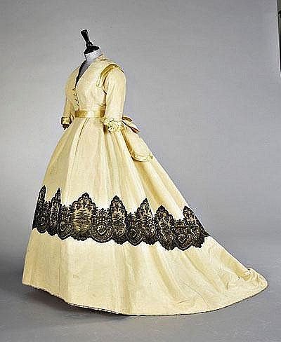 Pale yellow ottoman velvet evening gown, circa 1865, the bodice with yellow satin trimming and butt…