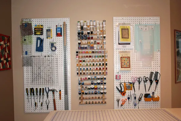 Pegboard on wall to organise sewing and quilting notions / tools.