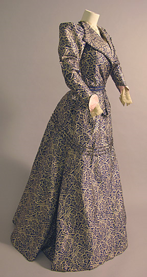 Printed blue silk dress with lace cuffs and silver braid and blue sequin trim, by Sarah Fullerton M…