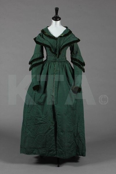 Item Description: A bottle green silk pelisse robe, late 1830s-early 1840s, lightly padded and line…