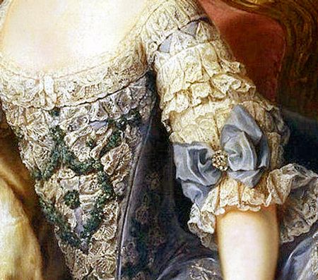 low scooped neckline to bodice with intricate lace trim; stomacher of cream lace and green embroide…