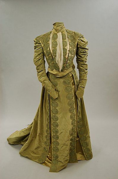 A green satin grosgrain afternoon dress, circa 1900: the bodice is trimmed with satin and applied w…