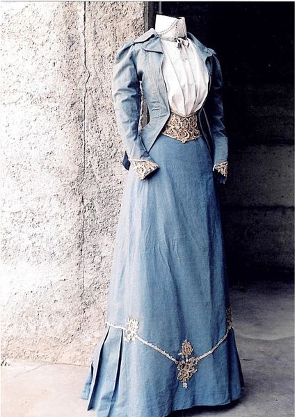 Circa 1890, blue cotton walking suit. Jacket and skirt with detail of Venetian point lace and glass…