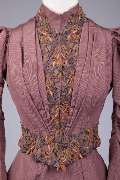 c 1892-1893.  Brown Faille Bodice fitted with many stays, fastening in front.  Inverted folds of fa…